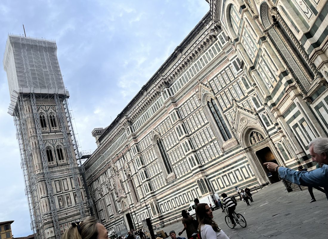 The marble facade of Florence Cathedral beside Giotto's Bell Tower