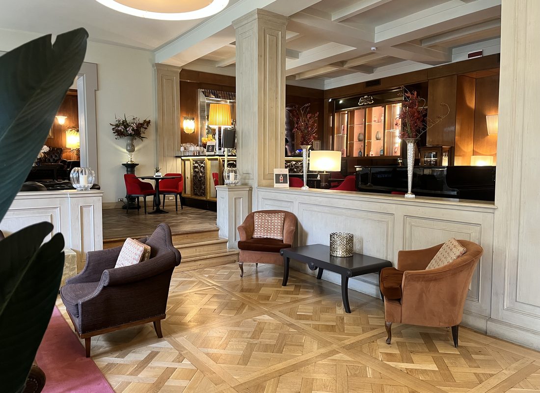 Elegant hotel lounge with velvet armchairs and a parquet floor